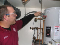 one of our techs is checking a water heater